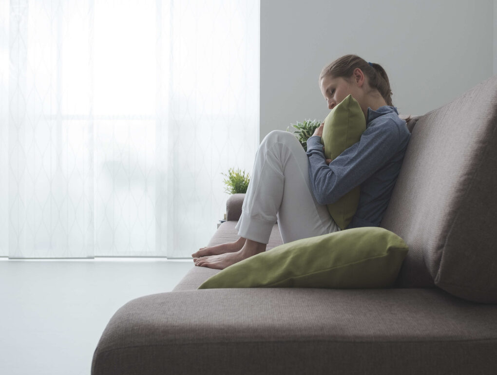 Woman Hugging a Pillow